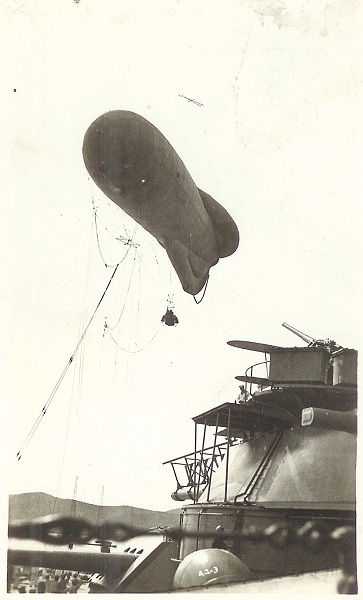  A kite balloon has been deployed from the USS Arizona. The kite balloon has a two man crew. 